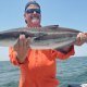 angler with a ling fish