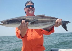 angler with a ling fish