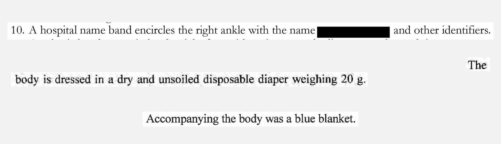 A snippet of black text on a white background containing three descriptive lines. The first line is numbered “10” and mentions a hospital name band on a right ankle, with the baby’s name redacted by a black bar. The second line states that the “body is dressed in a dry and unsoiled disposable diaper weighing 20 g.” The final line, centered below, notes that a blue blanket accompanied the body.