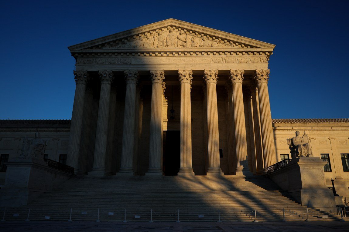 A dark shadow falls across the Supreme Court building.