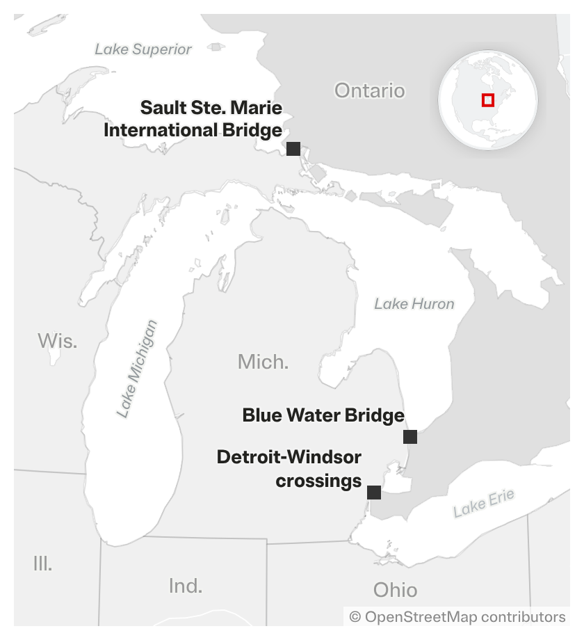 A regional map highlights key international border crossings between Michigan and Ontario, including the Sault Ste. Marie International Bridge, the Blue Water Bridge and Detroit-Windsor crossings. Surrounding Great Lakes — Lake Superior, Lake Michigan, Lake Huron and Lake Erie — are labeled alongside neighboring U.S. states.